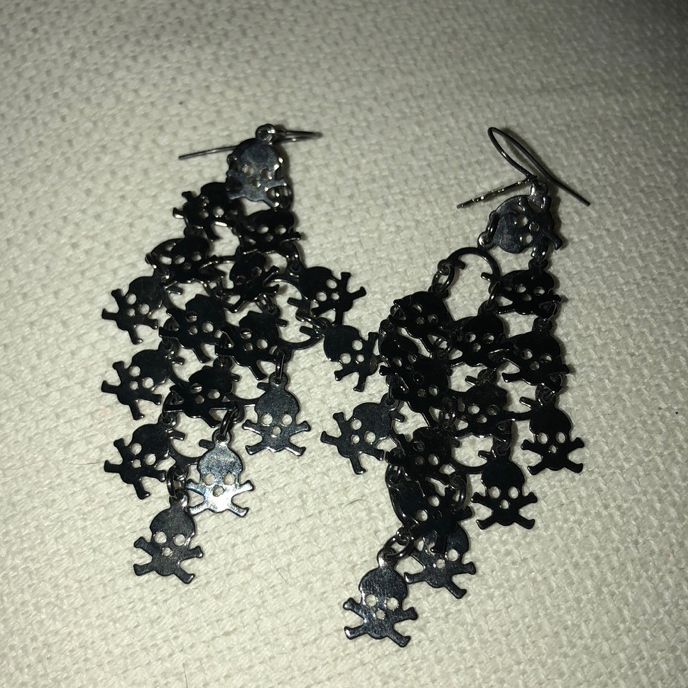 Scull and cross dangling never worn earrings.
